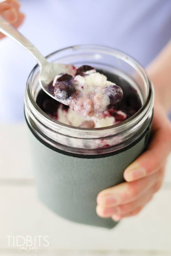 A whipped cream dollop in a mason jar with a dessert
