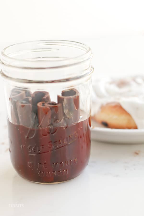 A glass jar with cinnamon extract in it