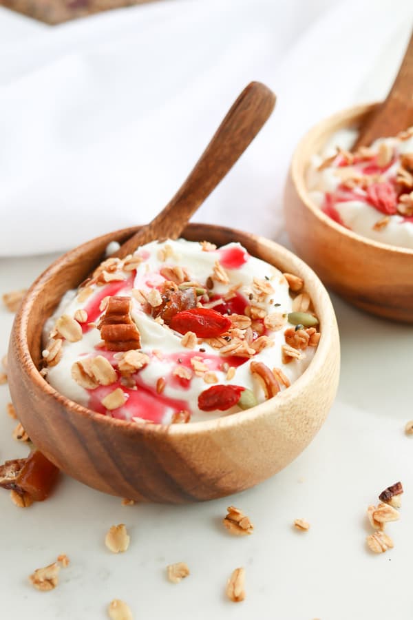 Instant Pot yogurt in a wood bowl with granola