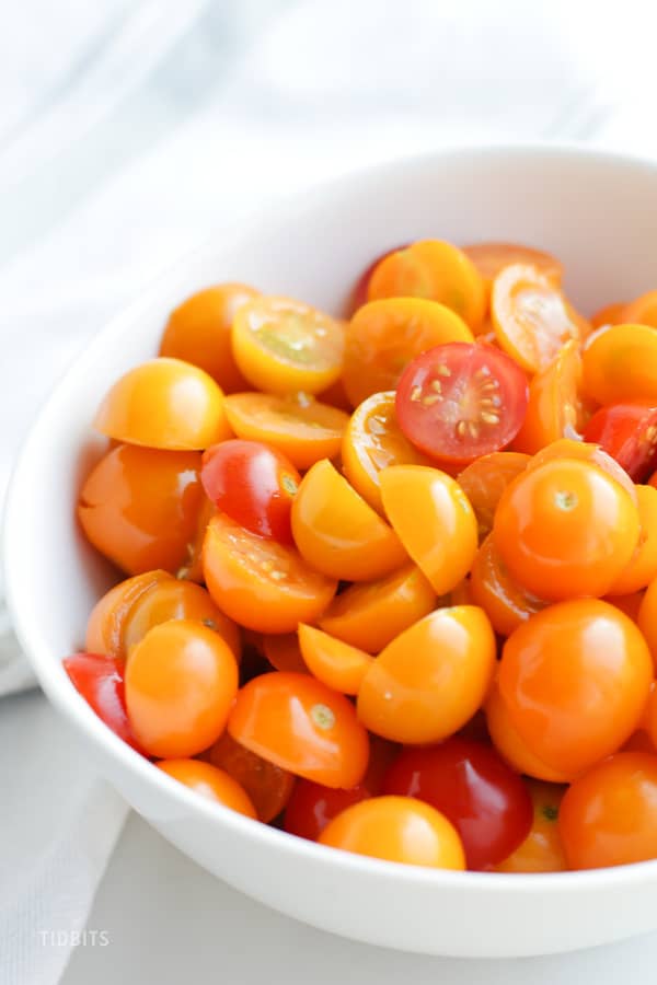 A bowl of halved cherry tomatoes