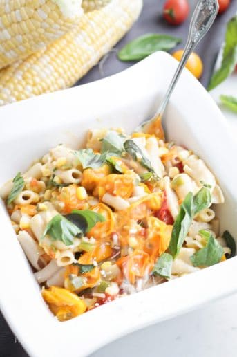A bowl of Sweet Corn and Tomato Pasta with a fork