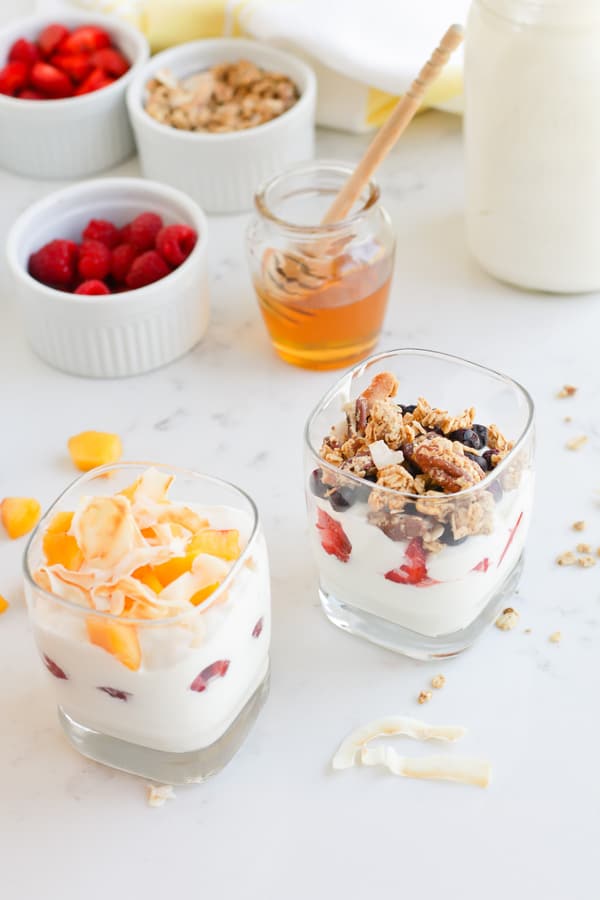 Two glasses of Instant Pot Yogurt Parfait with different toppings