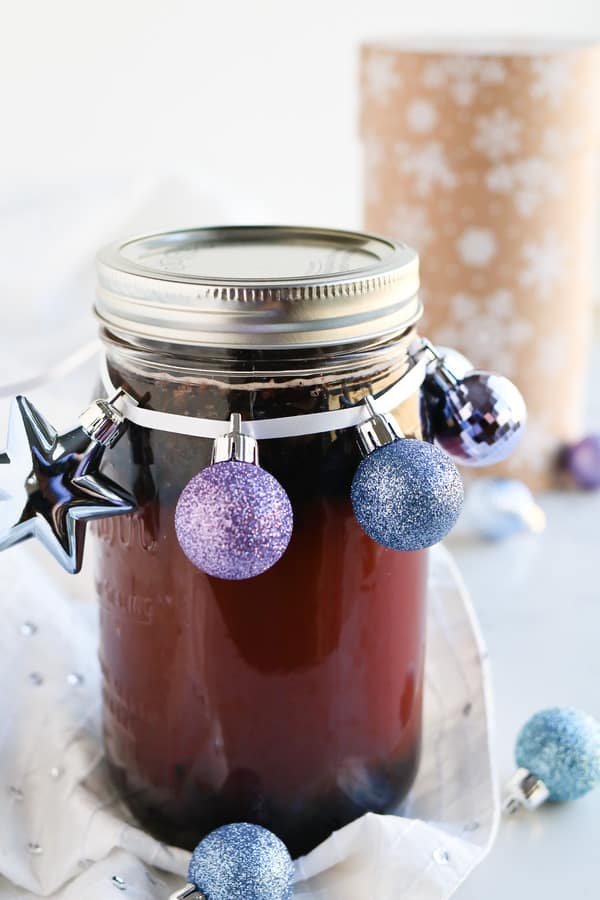 A jar of Pressure Cooker Elderberry Juice in a jar with Christmas decorations