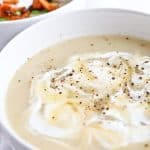 A bowl of Pressure cooker baked potato soup on a white cloth