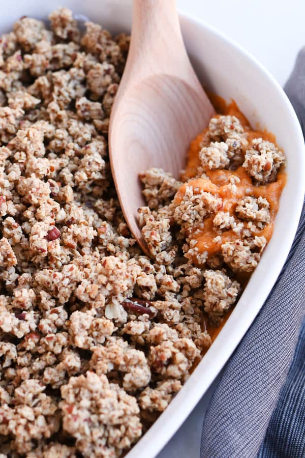 Sweet Potato Casserole with a pecan crumble in a white dish