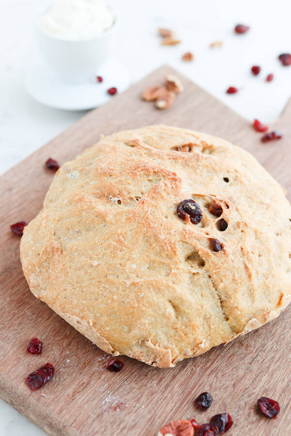 Cranberry Pecan Crusty Bread on a wooden chopping board