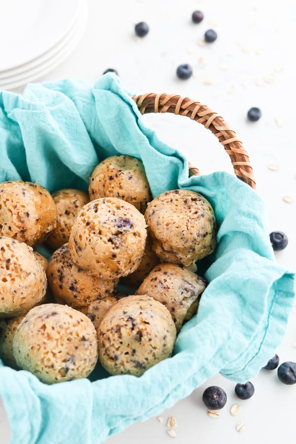 Oatmeal muffins in a basket with a blue cloth