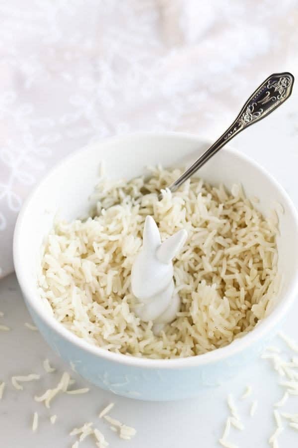 white rice in a blue bowl with a spoon