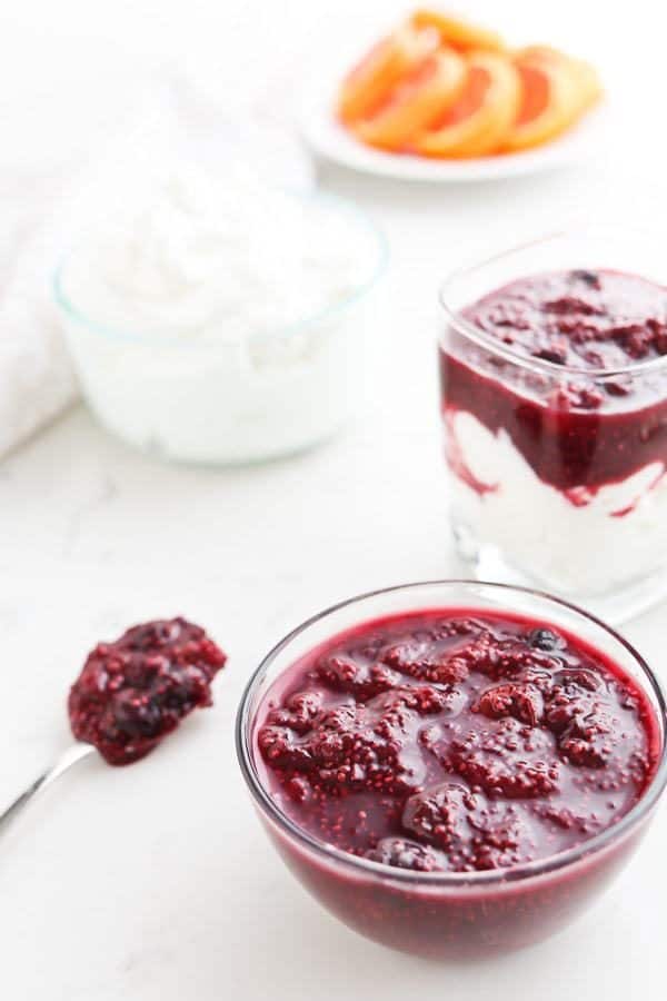 Instant Pot Triple Berry Chia Jam in a glass bowl over yogurt