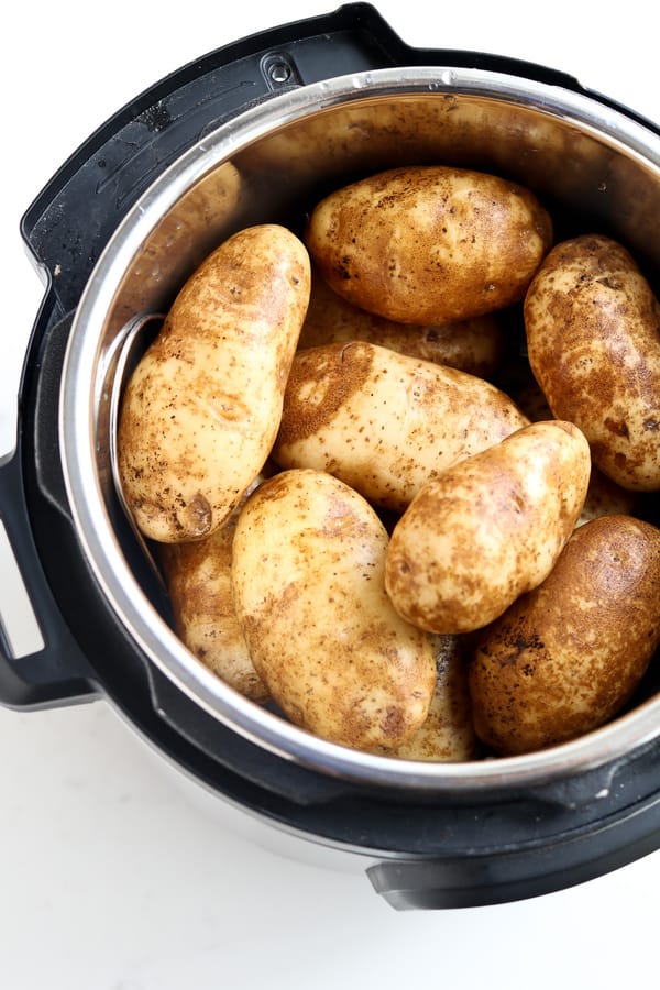 Instant Pot Baked Potato staked in a pressure cooker pot