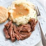 Instant Pot Pot Roast on plate with mashed potato and biscuit