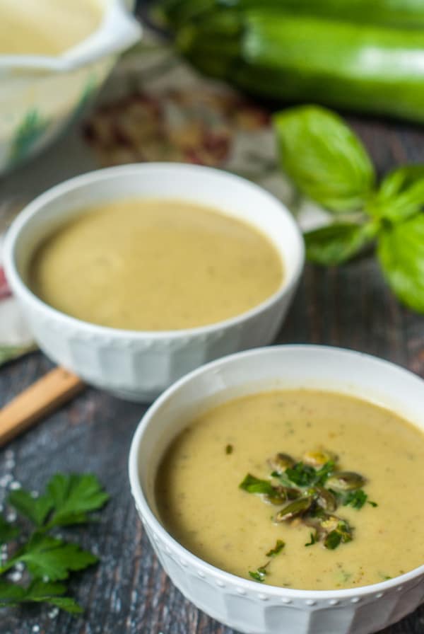2 white bowls with zucchini soup