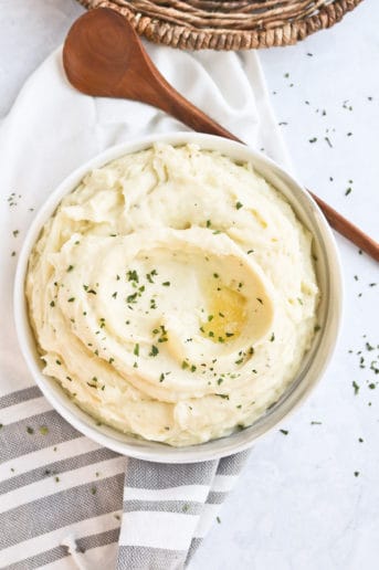 Bowl of creamy mashed potatoes with butter