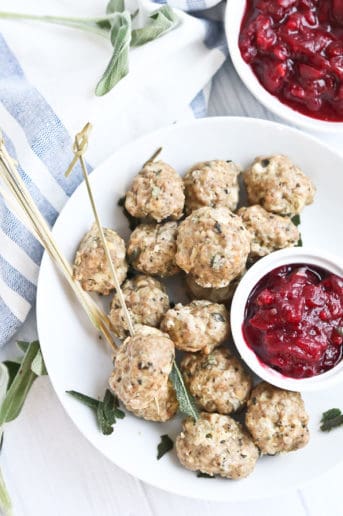 Turkey Meatballs on a white plate with cranberry sauce