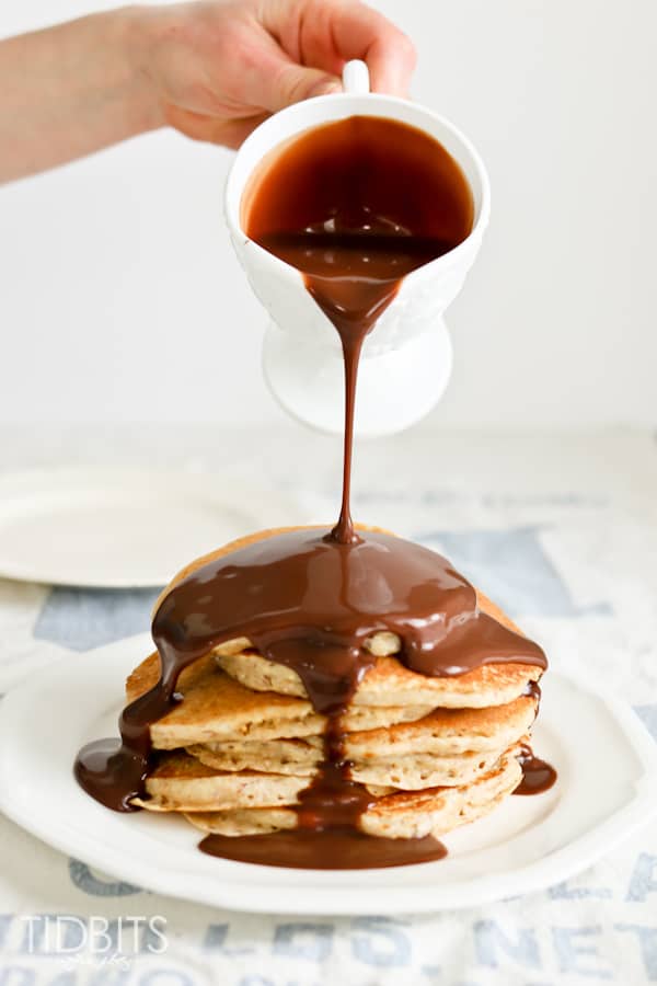 chocolate syrup pouring over pancakes