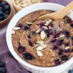 Baking dish with blueberry oatmeal and sliced almonds on top