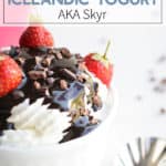 Instant Pot Icelandic Skyr Yogurt in a white bowl with chocolate syrup and strawberries