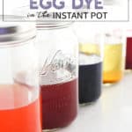 Row of mason jars with different colors of easter egg dye