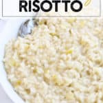 Instant Pot Risotto in a white bowl with a spoon