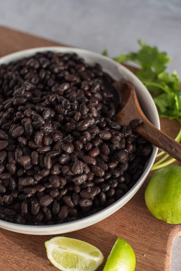 Instant Pot Black Beans in a white bowl with a cilantro