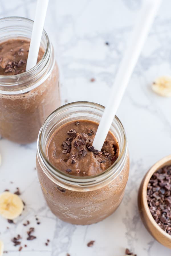 Crio Bru Smoothie in a mason jar with a white straw and cacao nibs