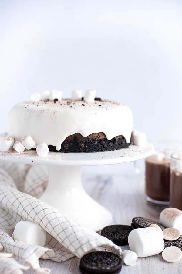Hot chocolate cheesecake with marshmallow ganache sitting on a white dish