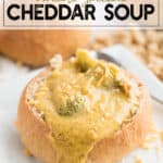 Broccoli Cheddar soup in a bread bowl with cheddar cheese on top