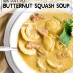 butternut squash soup with ravioli and sausage in a white bowl with a spoon