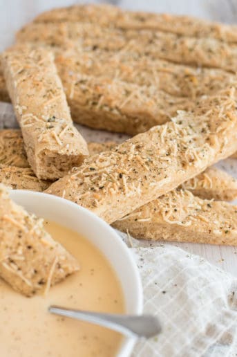 whole wheat breadsticks with parmesan and herbs with a bowl of soup