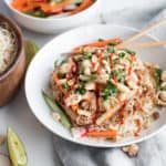 Instant Pot Bahn Mi in a white bowl with carrots and cilantro and chopsticks