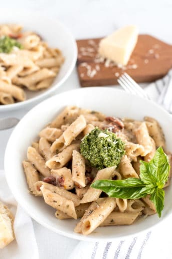 bowl of pasta with sun-dried tomatoes and pesto