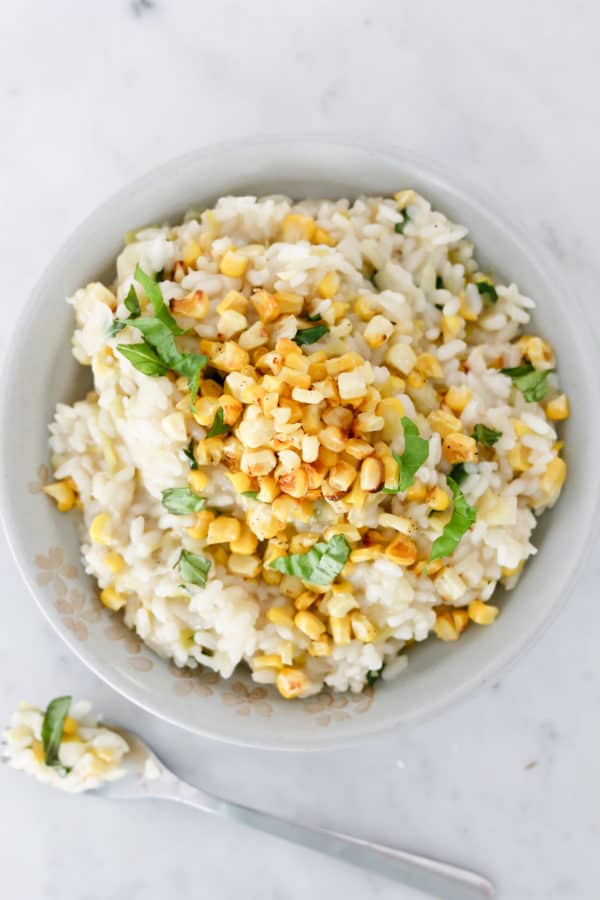 risotto topped with corn and basil