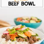 Korean Beef topped with radishes, carrots, and cucumbers in a white bowl of rice