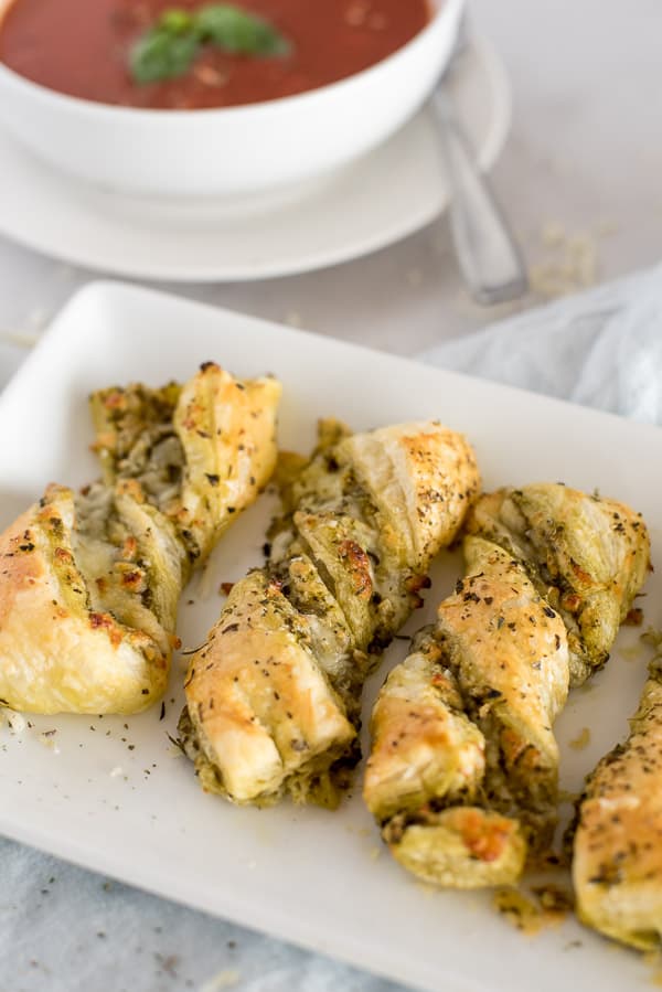 twisted pesto breadsticks on a white plate