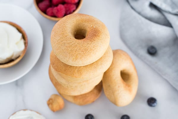 Bagels stacked on top of each other on a gray napkin