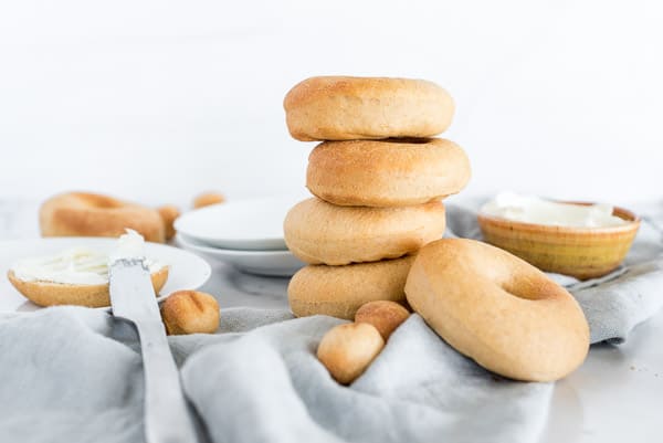 Bagels stacked on top of each other on a gray napkin