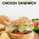 chicken with green sauce on a bagel with tomato and spinach