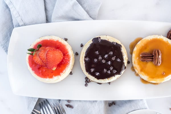 mini cheesecakes with chocolate, caramel pecan and strawberry toppings
