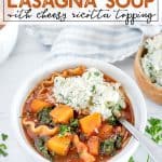 instant pot lasagna soup with a cheese topping in a white bowl near a loaf of crusty bread
